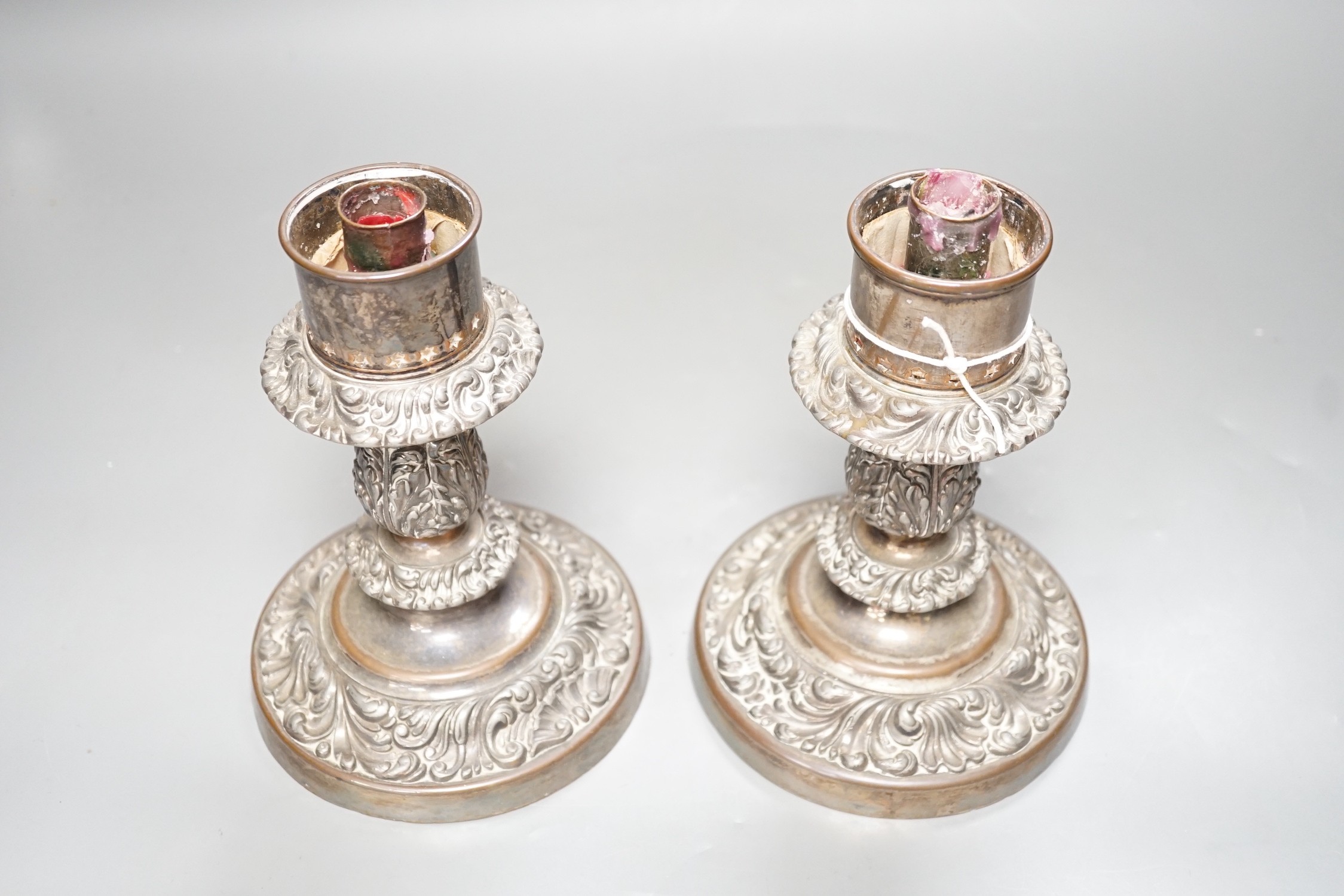 A pair of Victorian silver plated ships storm light candlesticks, glass funnels missing, 19cms high